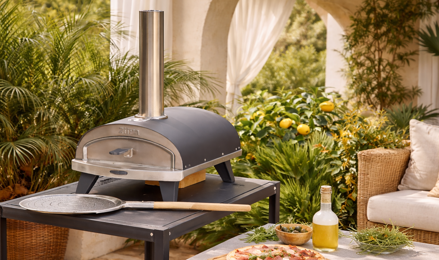 Compact outdoor pizza oven with chimney placed on a table, ideal for garden and patio cooking